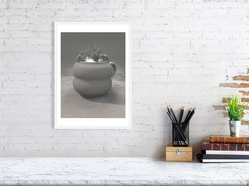 Framed trippy clay cup digital art print on Hahnemühle Photorag 300GSM paper, displayed on modern white brick wall with desk accessories.