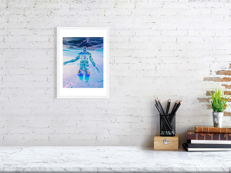 Framed digital art print titled "Head In The Clouds" on a white brick wall, featuring trippy, modern design in vibrant colors