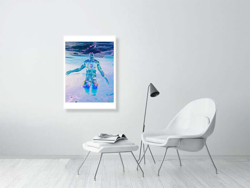 Framed digital art print "Head In The Clouds" on a modern wall above a white chair and table with a black lamp, featuring trippy design.