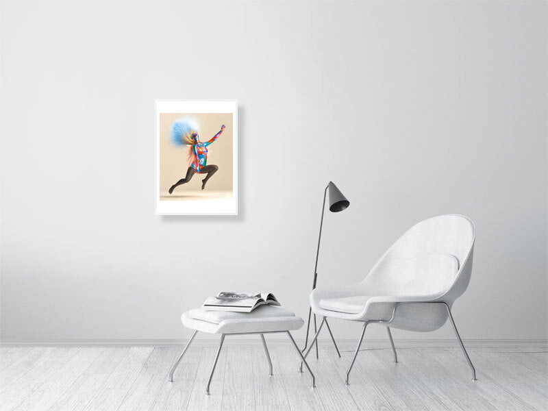 Modern trippy digital art print on framed canvas in minimalist living room with white chair and floor lamp.