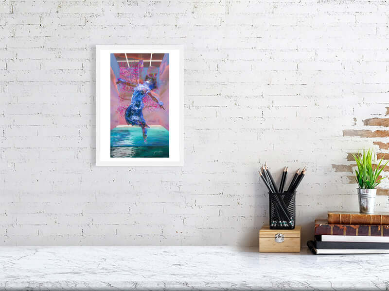 Framed digital art print on white brick wall with desk, books, and plant decor.