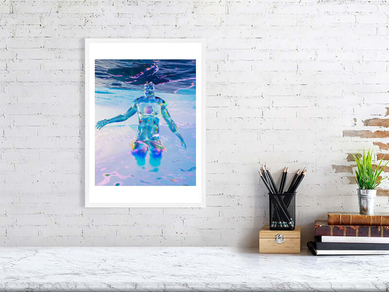 Framed digital art print "Head In The Clouds" on a white wall, featuring a trippy, modern design with vibrant colors, displayed on desk.