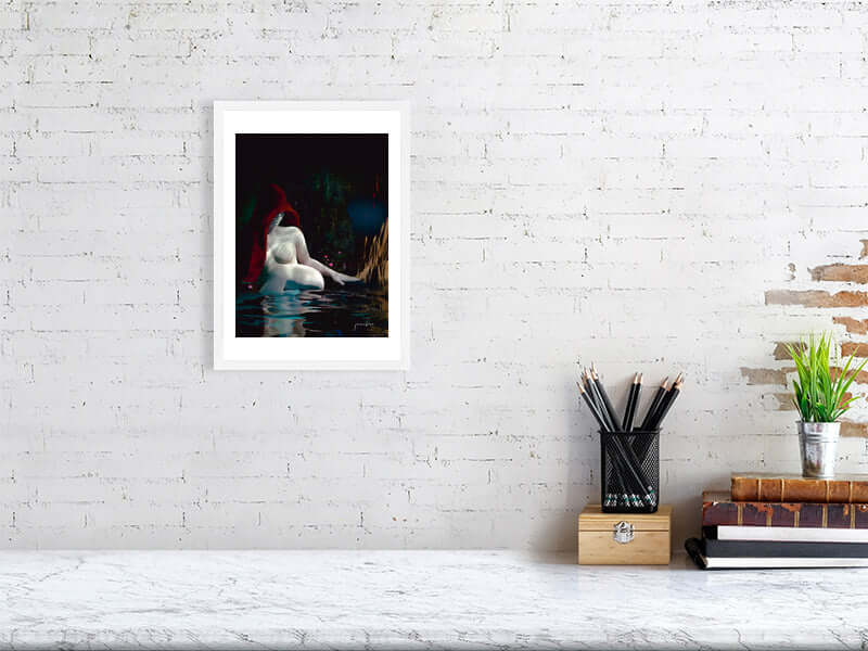 White frame with modern trippy digital art print on a textured white brick wall above a marble desk with pencils and books.