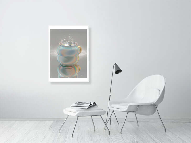 Framed trippy modern digital art print of a cup displayed on a wall in a minimalist room with a white chair and table